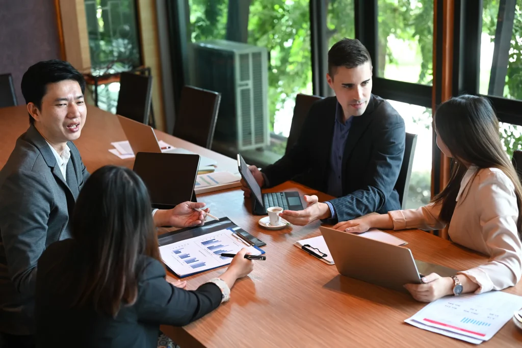 Business professionals in a meeting discussing financial reports and strategy.